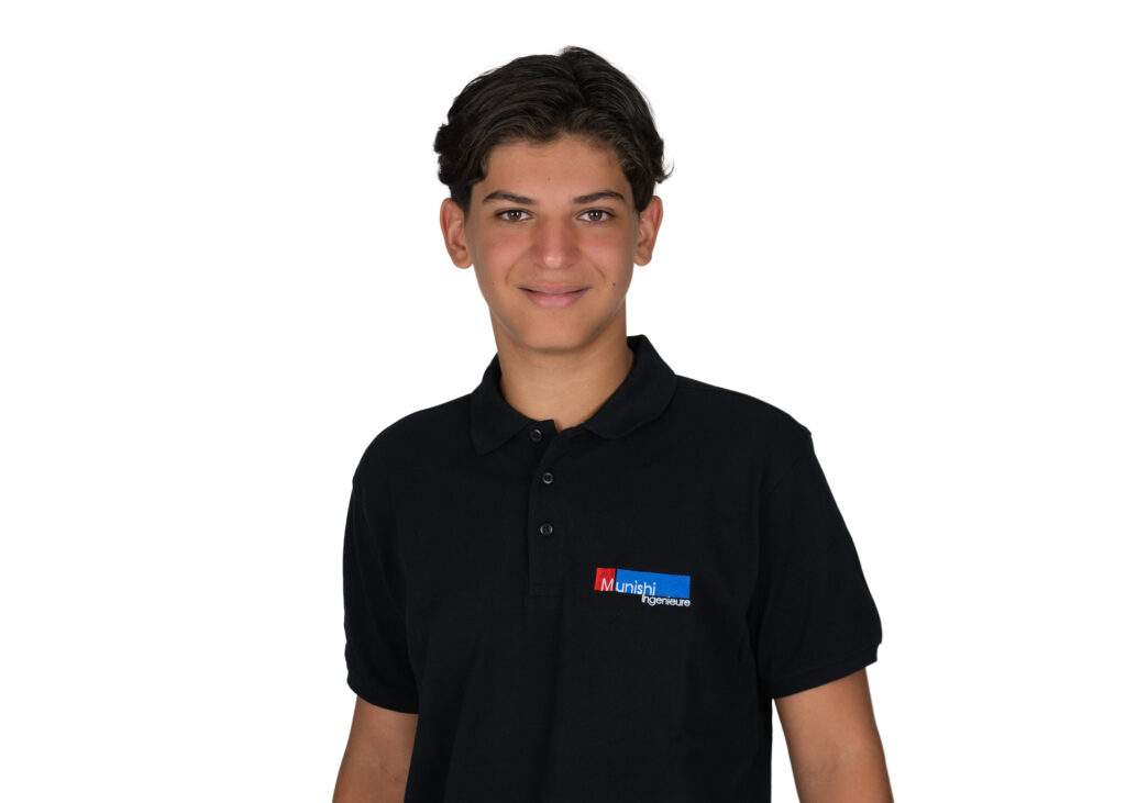 Portrait of a young man with short dark hair wearing a black polo shirt with a small red-blue logo on the chest, against a white background.